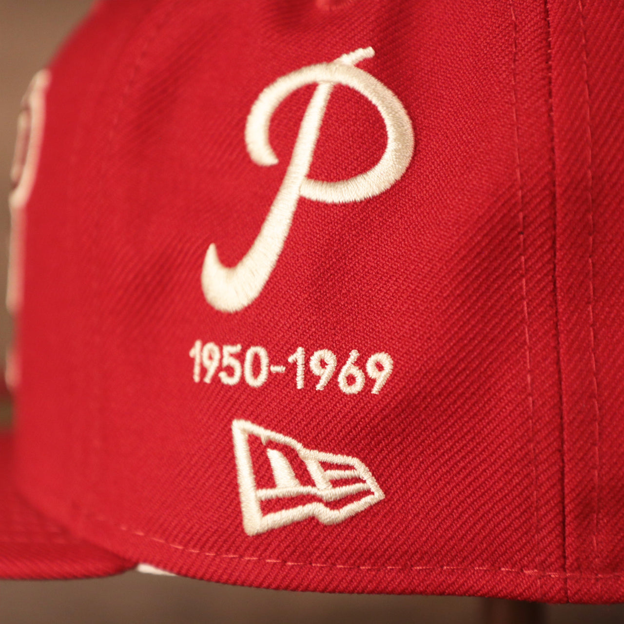 The Philadelphia Phillies logo on the red New Era 59fifty with all over patch fitted logo history of the team.