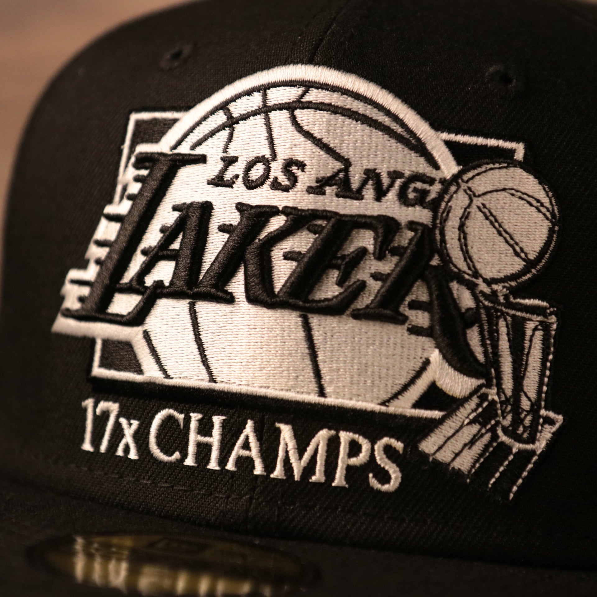 The front side logo of the black 17x Lakers champs 59fifty hat by New Era.