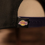 The Los Angeles Tag on the adjustable strap of the Los Angeles Lakers black/purple 950 fitted cap.