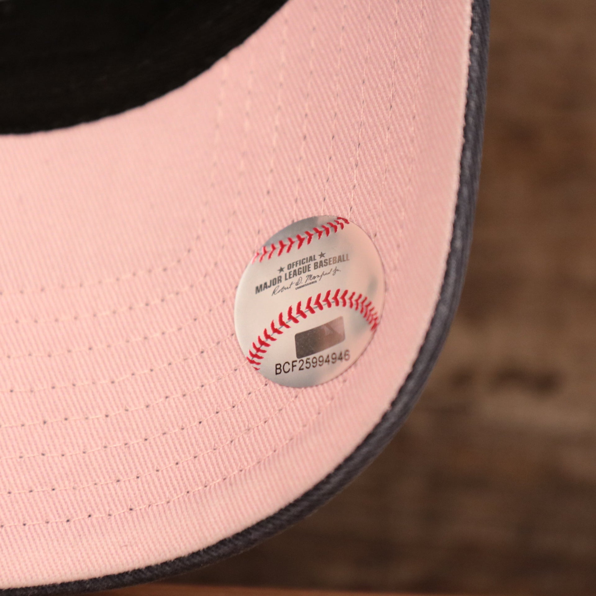 The Official Major League Baseball tag on the Yankees pink bottom dad hat.