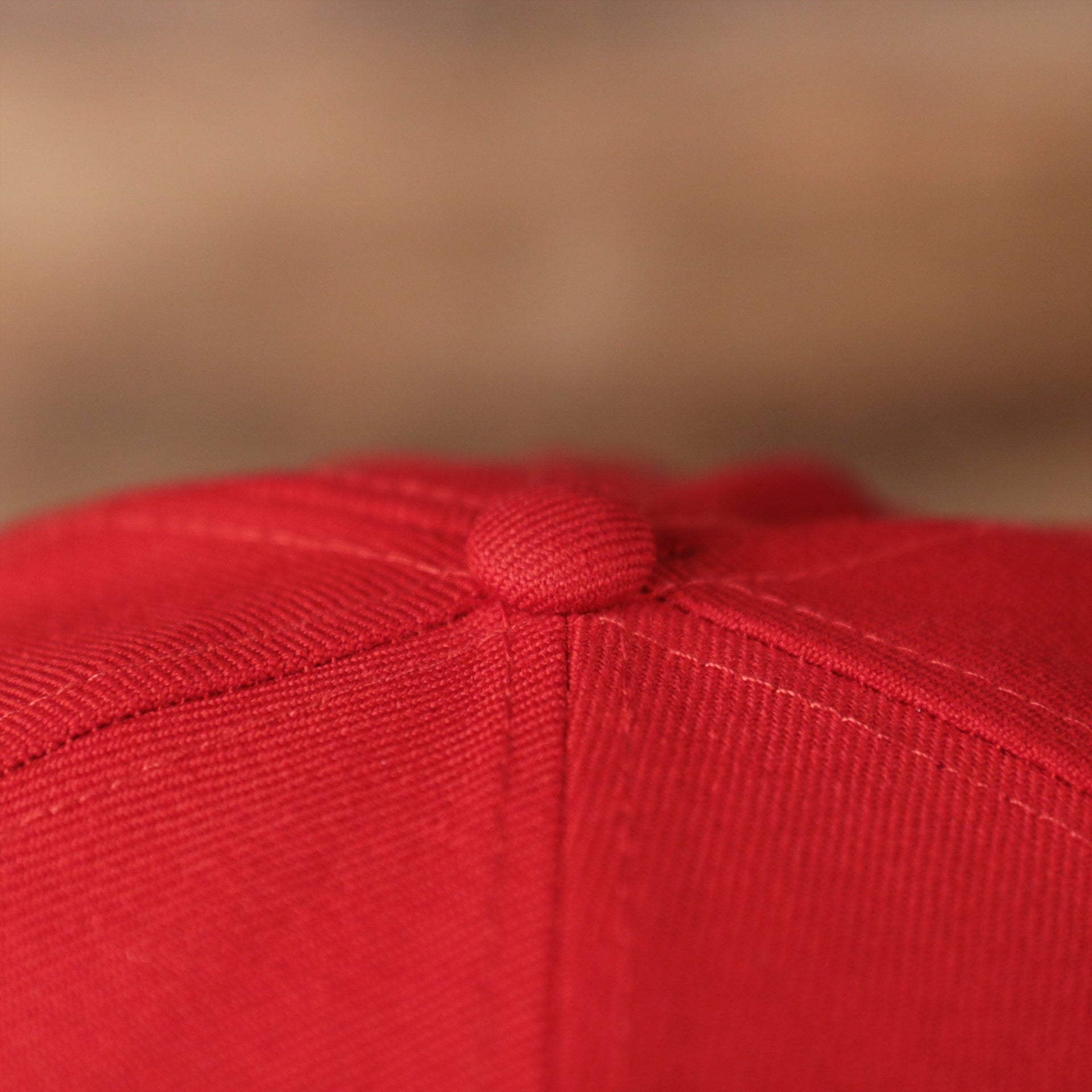 The top of the red vintage all over embroidered fitted cap by New Era.