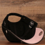 An inside look of the black New York Yankees pink brim bottom adjustable cap.