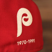 The back side of the red New Era 59fifty has the logo of the Phillies used in 1970 by the team.
