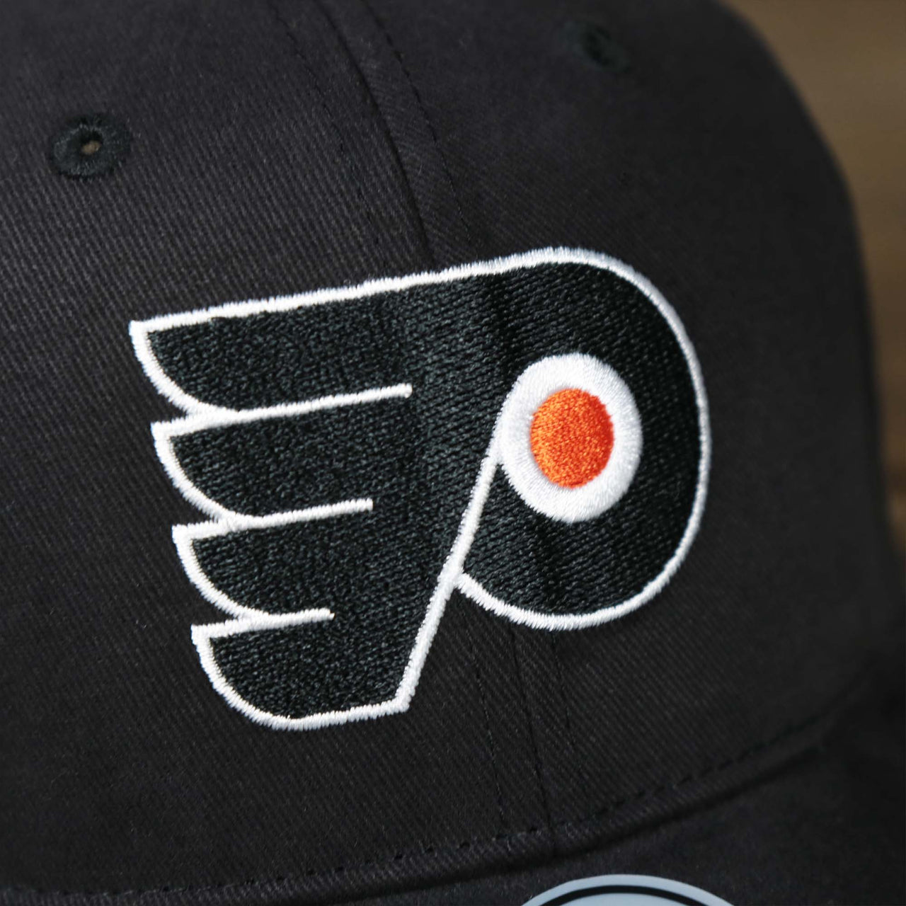 The flyers logo on the Infant Philadelphia Flyers Black Dad Hat | 47 Brand OSFM