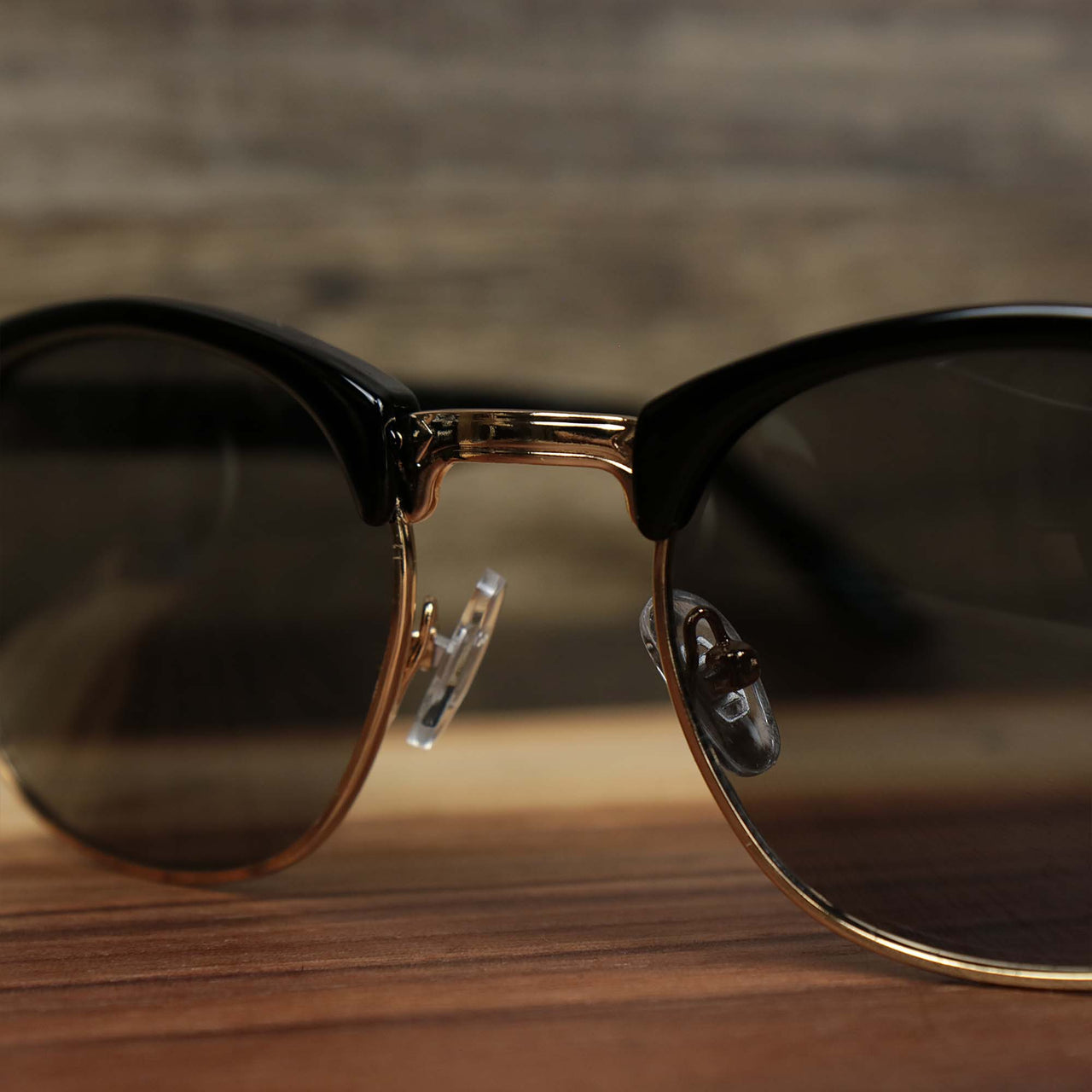 The bridge on the Round Frame Black Lens Sunglasses with Black Gold Frame