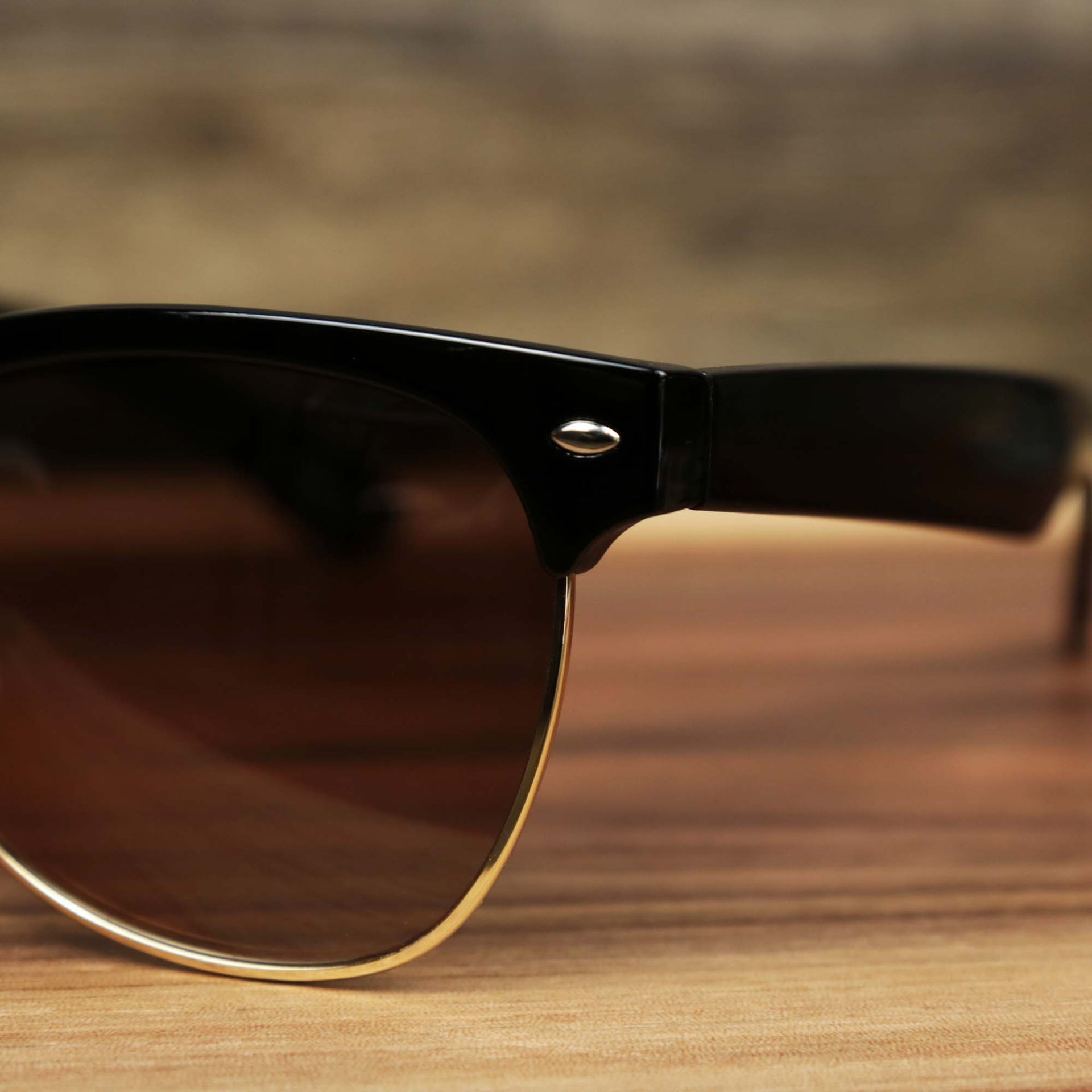 The hinge on the Thick Top and Metal Bottom Frame Brown Lens Sunglasses with Black Frame