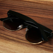 The Thick Top and Metal Bottom Frame Brown Lens Sunglasses with Black Frame folded up