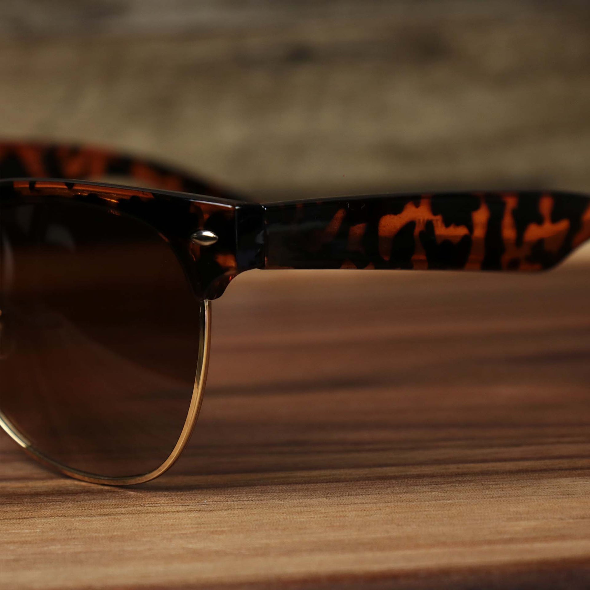 The hinge on the Thick Top and Metal Bottom Frame Brown Lens Sunglasses with Tortoise Frame