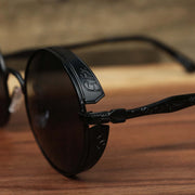 The hinge on the Round Frame Arched Bridge Black Lens Sunglasses with Black Frame