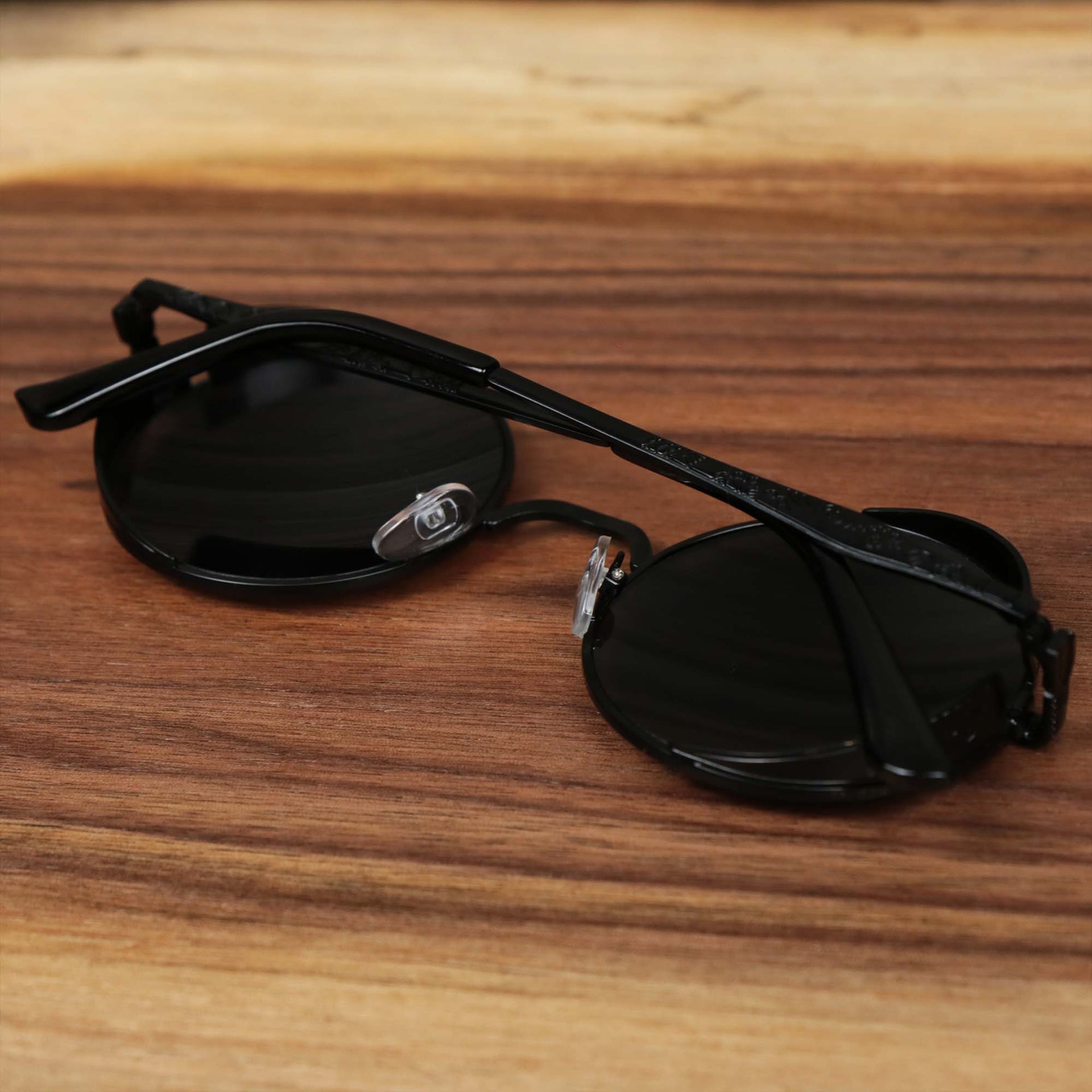 The Round Frame Arched Bridge Black Lens Sunglasses with Black Frame folded up