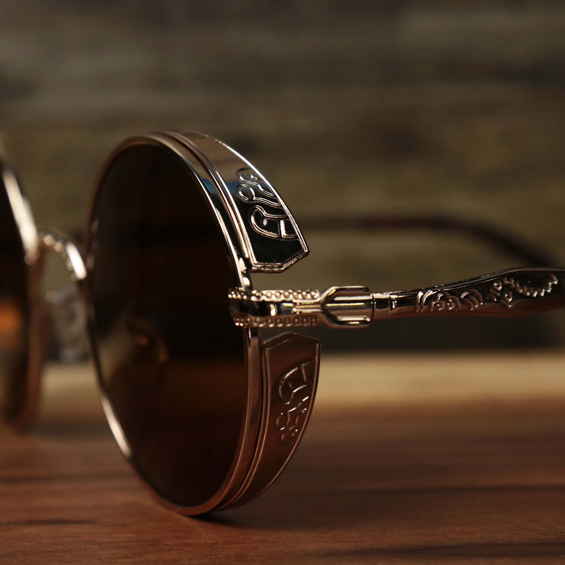 The hinge on the Round Frame Arched Bridge Brown Lens Sunglasses with Gold Frame