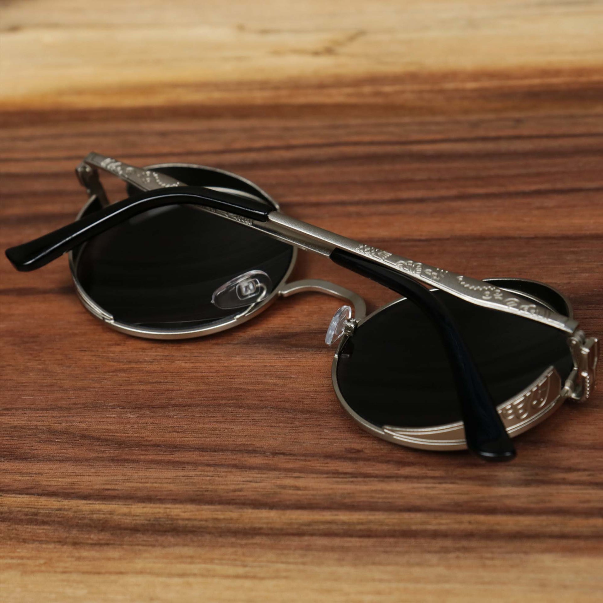 The Round Frame Arched Bridge Black Lens Sunglasses with Silver Frame folded up