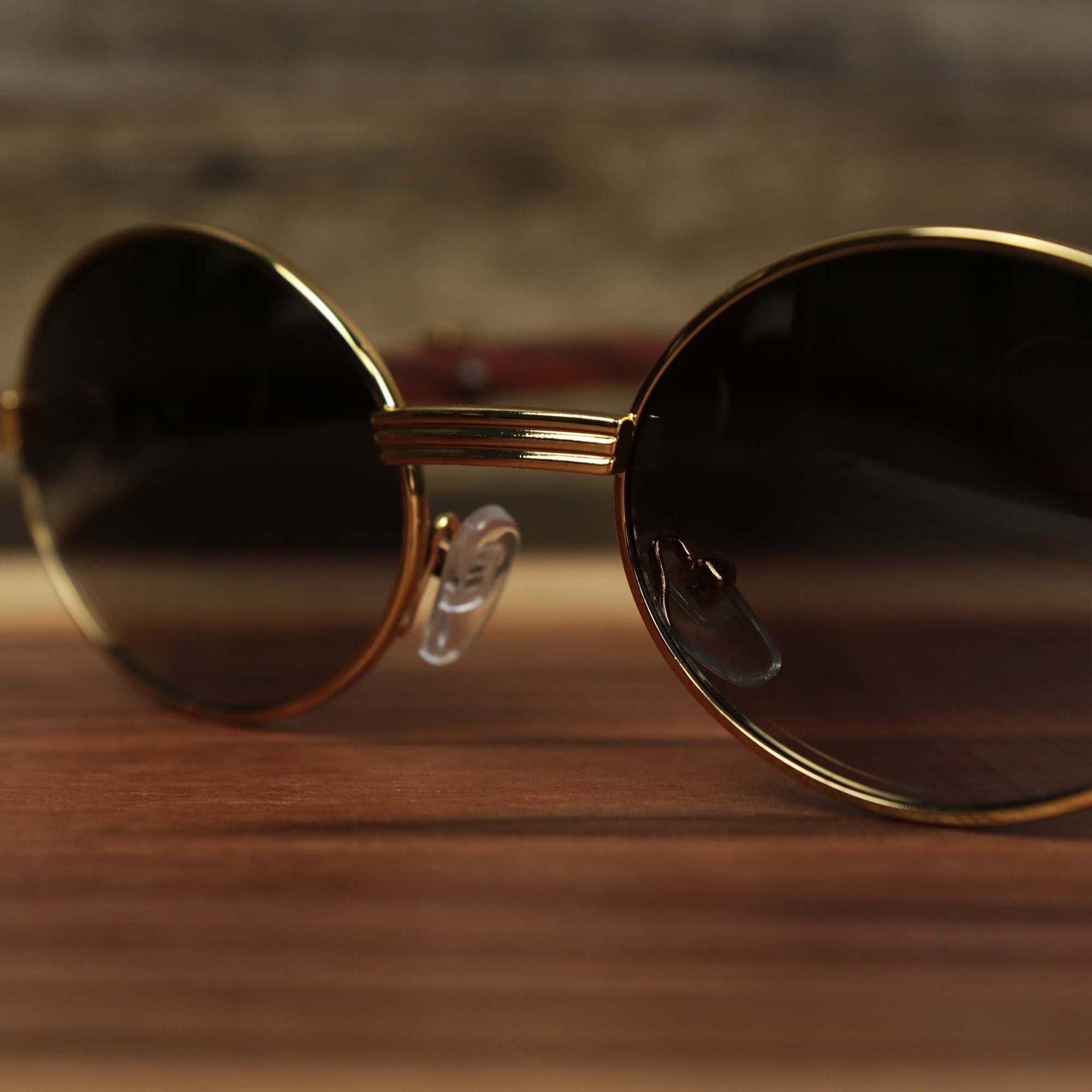 The bridge on the Oval 3 Row Frame Black Lens Sunglasses with Gold Frame