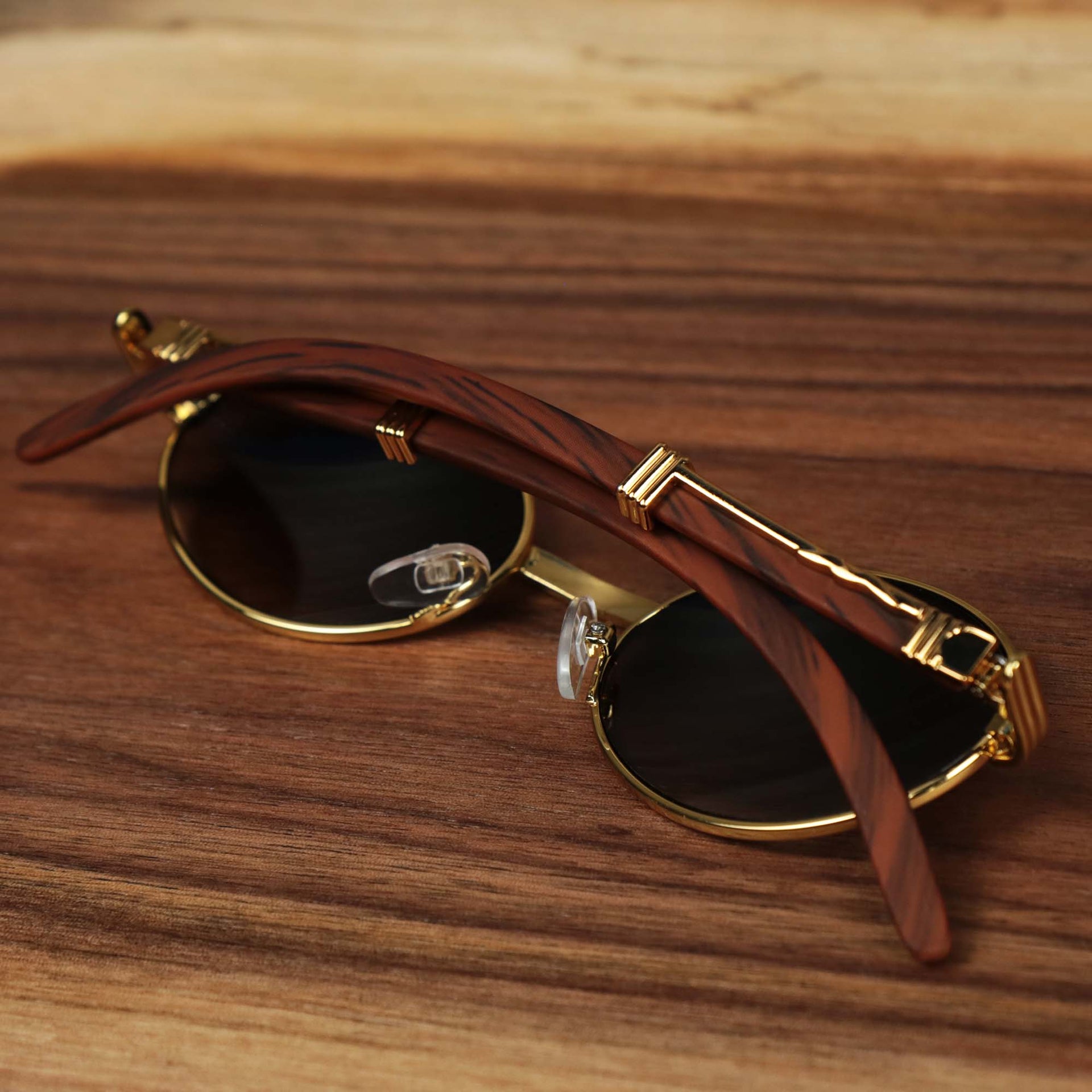 The Oval 3 Row Frame Black Lens Sunglasses with Gold Frame folded up