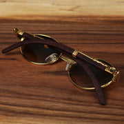 The Oval 3 Row Frame Black Gradient Lens Sunglasses with Gold Frame folded up