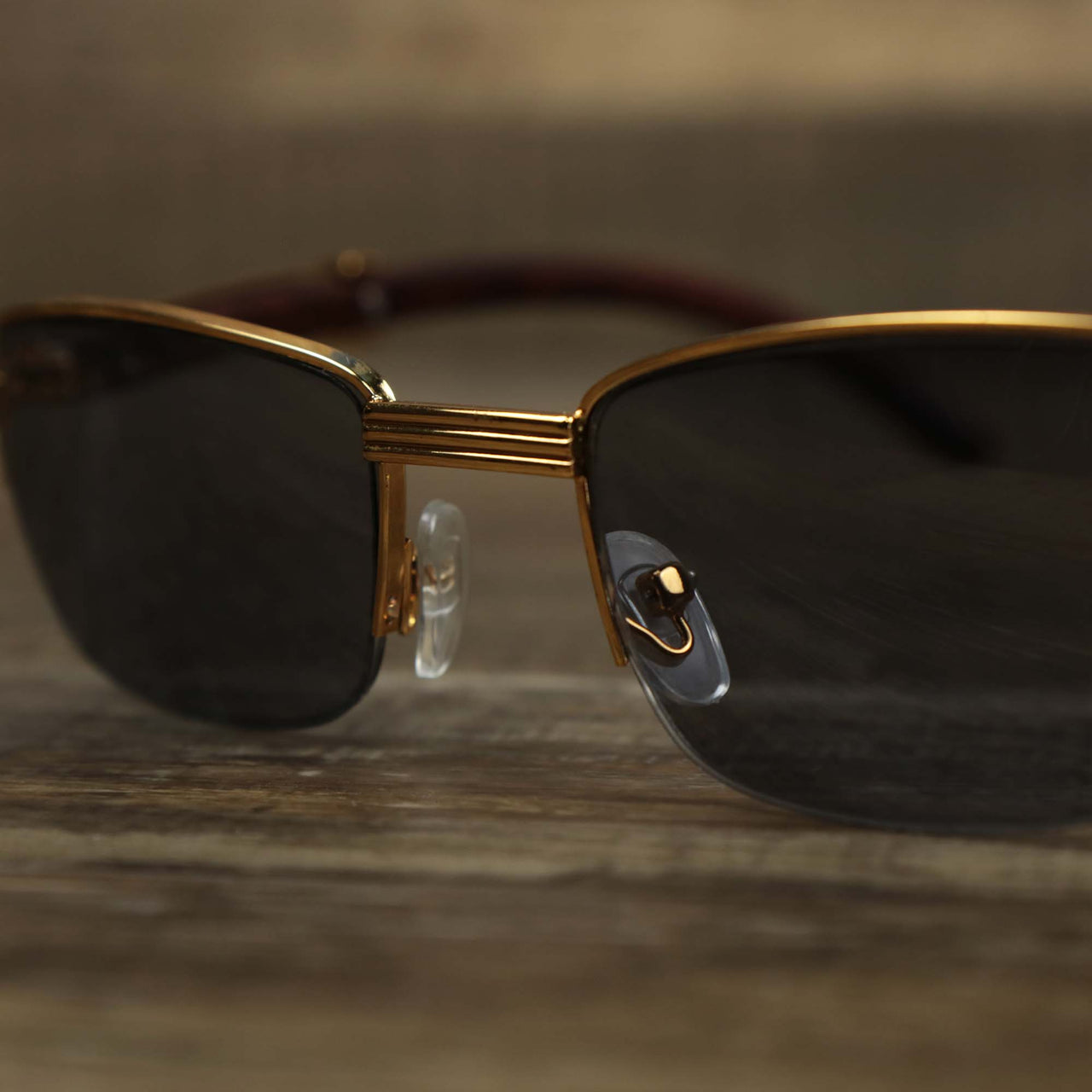 The bridge on the Rectangle 3 Row Frame Black Lens Sunglasses with Gold Frame