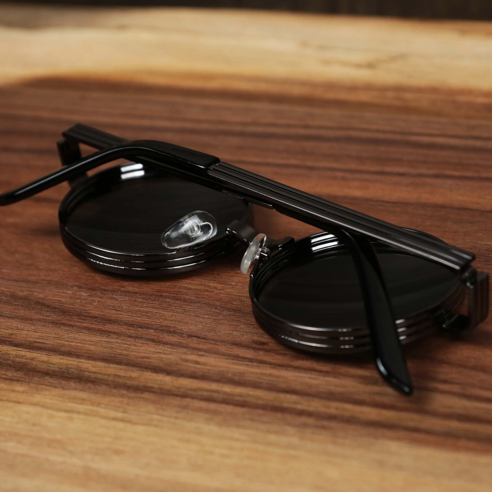 The Round 3 Row Frame Black Lens Sunglasses with Gunmetal Frame folded up