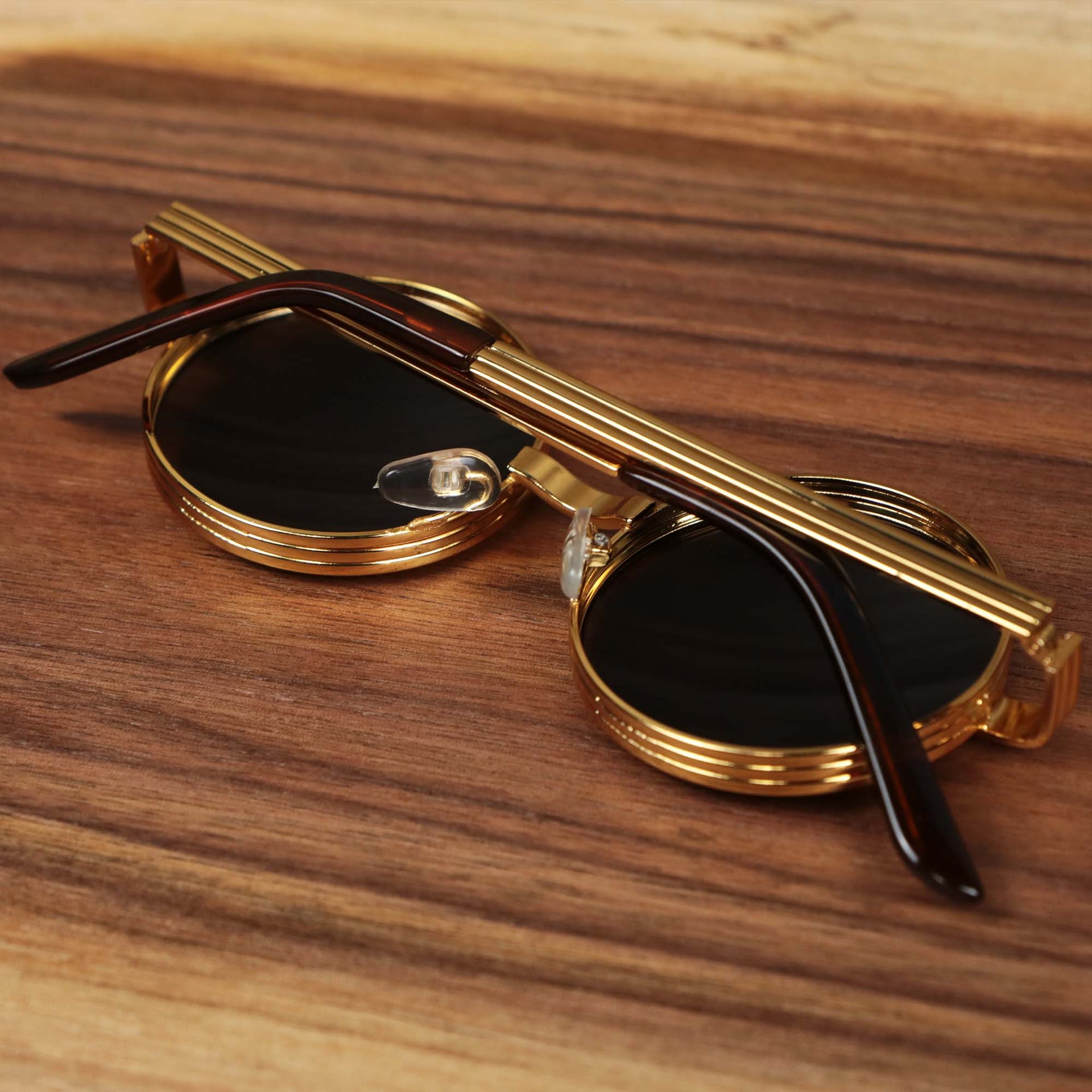 The Round 3 Row Frame Brown Lens Sunglasses with Gold Frame folded up