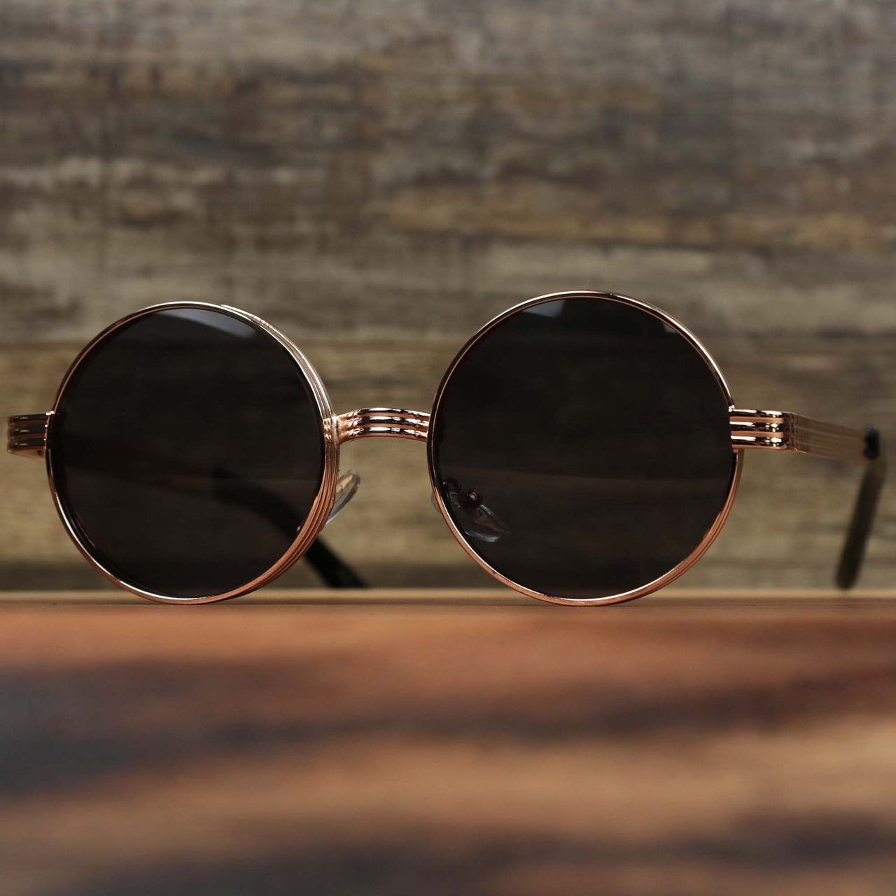 The Round 3 Row Frame Black Lens Sunglasses with Rose Gold Frame
