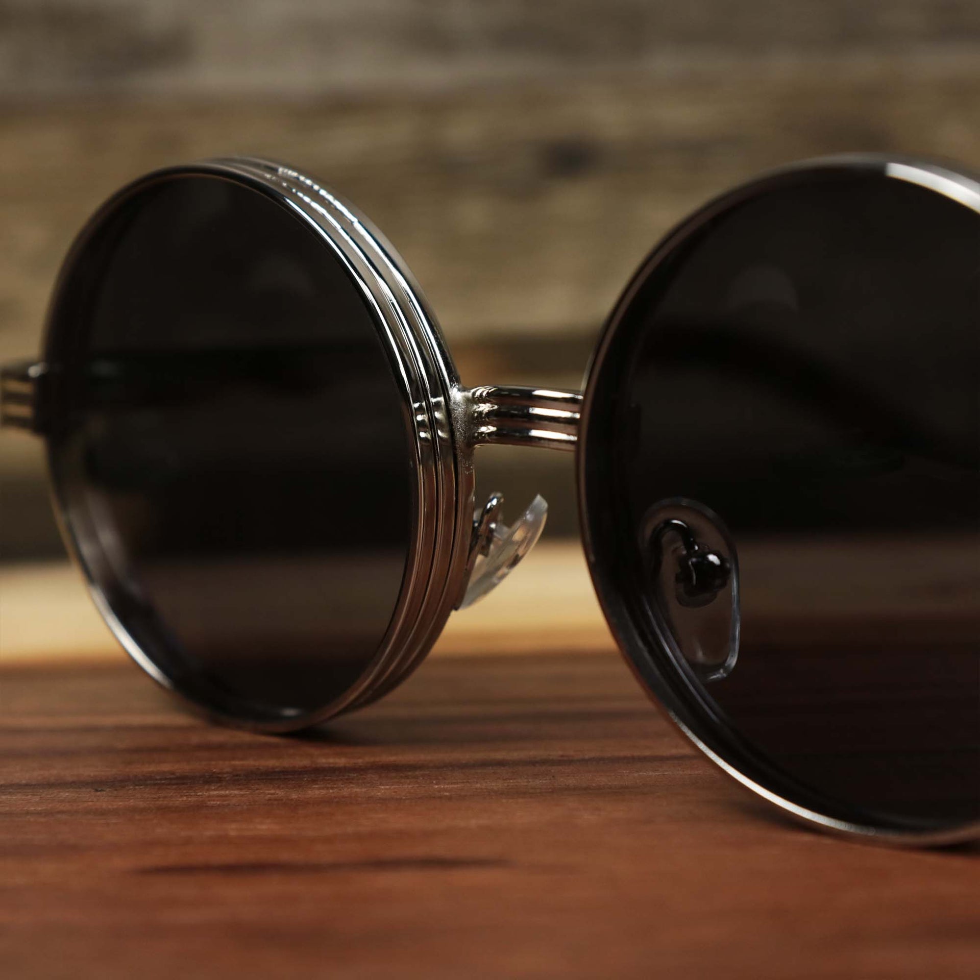 The bridge on the Round 3 Row Frame Black Lens Sunglasses with Silver Frame