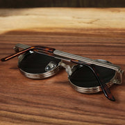 The Round 3 Row Frame Black Lens Sunglasses with Silver Frame folded up