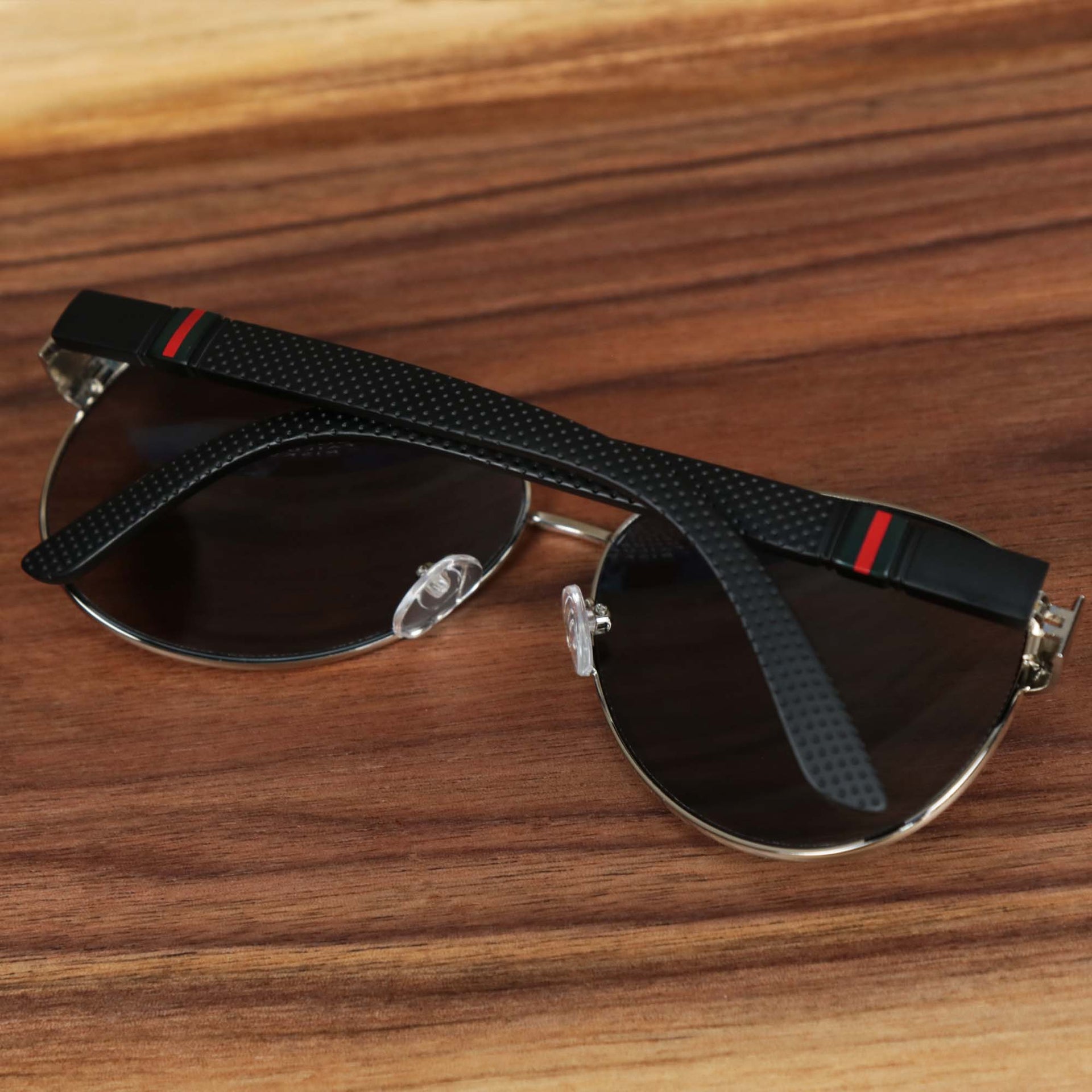 The Aviator Frame Racing Stripes Black Lens Sunglasses with Silver Frame folded up