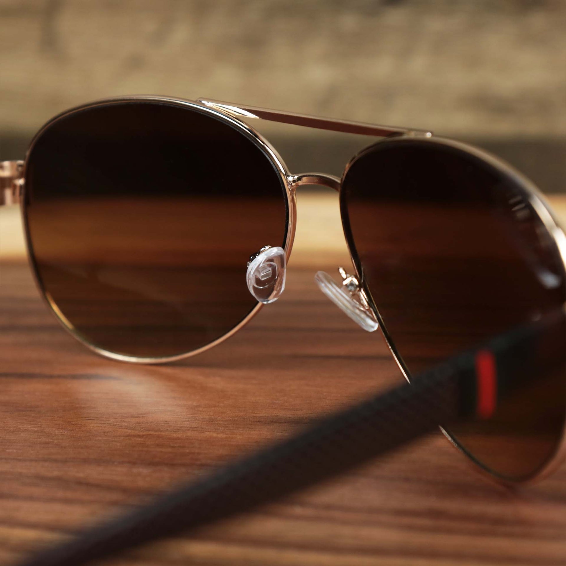 The inside of the Aviator Frame Racing Stripes Brown Lens Sunglasses with Rose Gold Frame