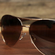 The bridge on the Aviator Frame Racing Stripes Brown Lens Sunglasses with Rose Gold Frame