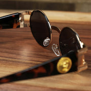 The inside of the Circle Frame Lion Head Emblem Black Lens Sunglasses with Rose Gold Frame