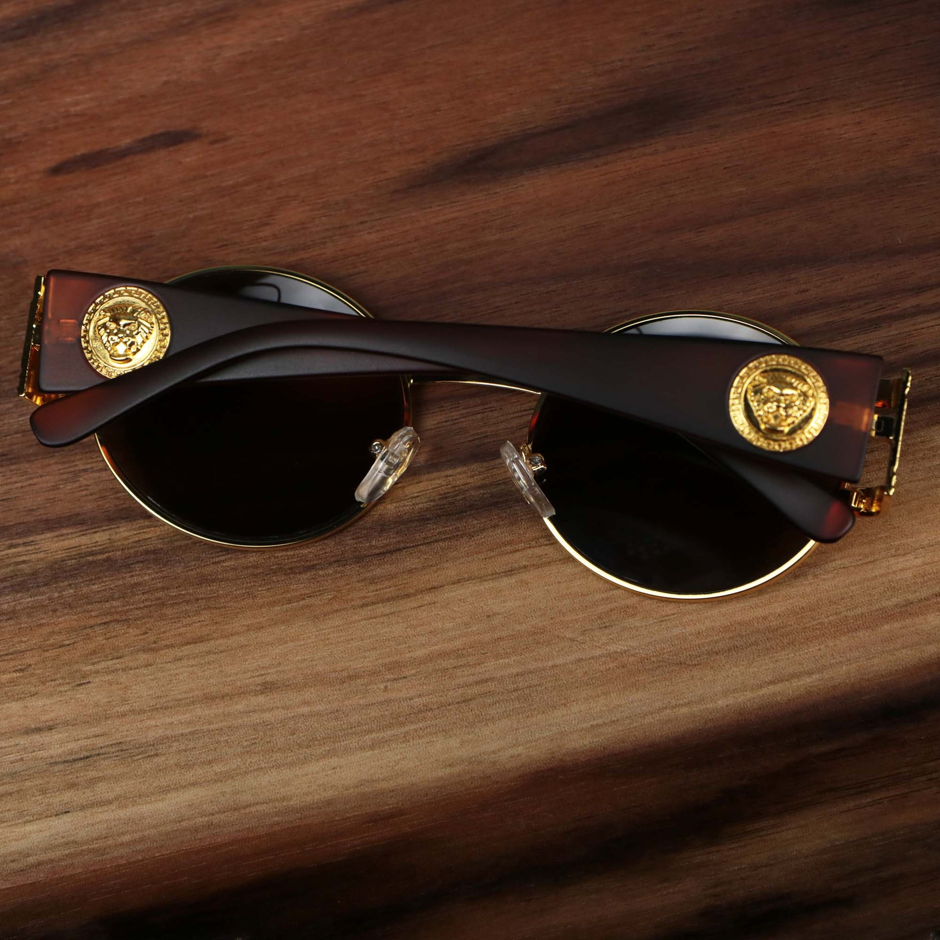 The Circle Frame Lion Head Emblem Brown Lens Sunglasses with Gold Frame folded up