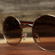 A close up of the bridge on the Circle Frame Lion Head Emblem Brown Lens Sunglasses with Rose Gold Frame