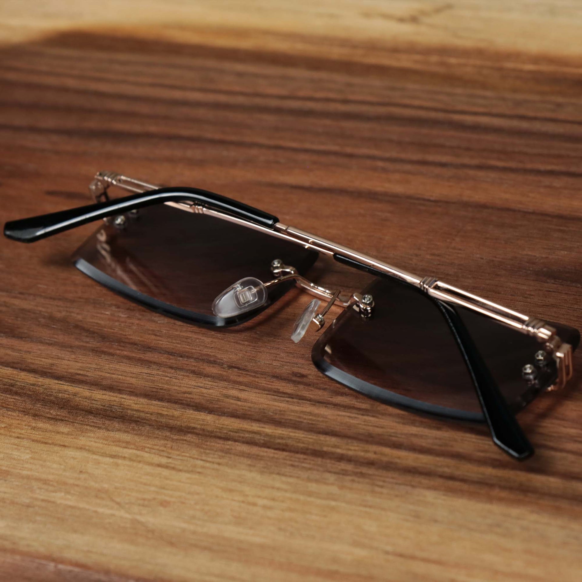 The Rectangle Frame Black Lens Sunglasses with Gold Frame folded up