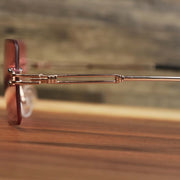 The hinge on the Rectangle Frame Pink Lens Sunglasses with Gold Frame
