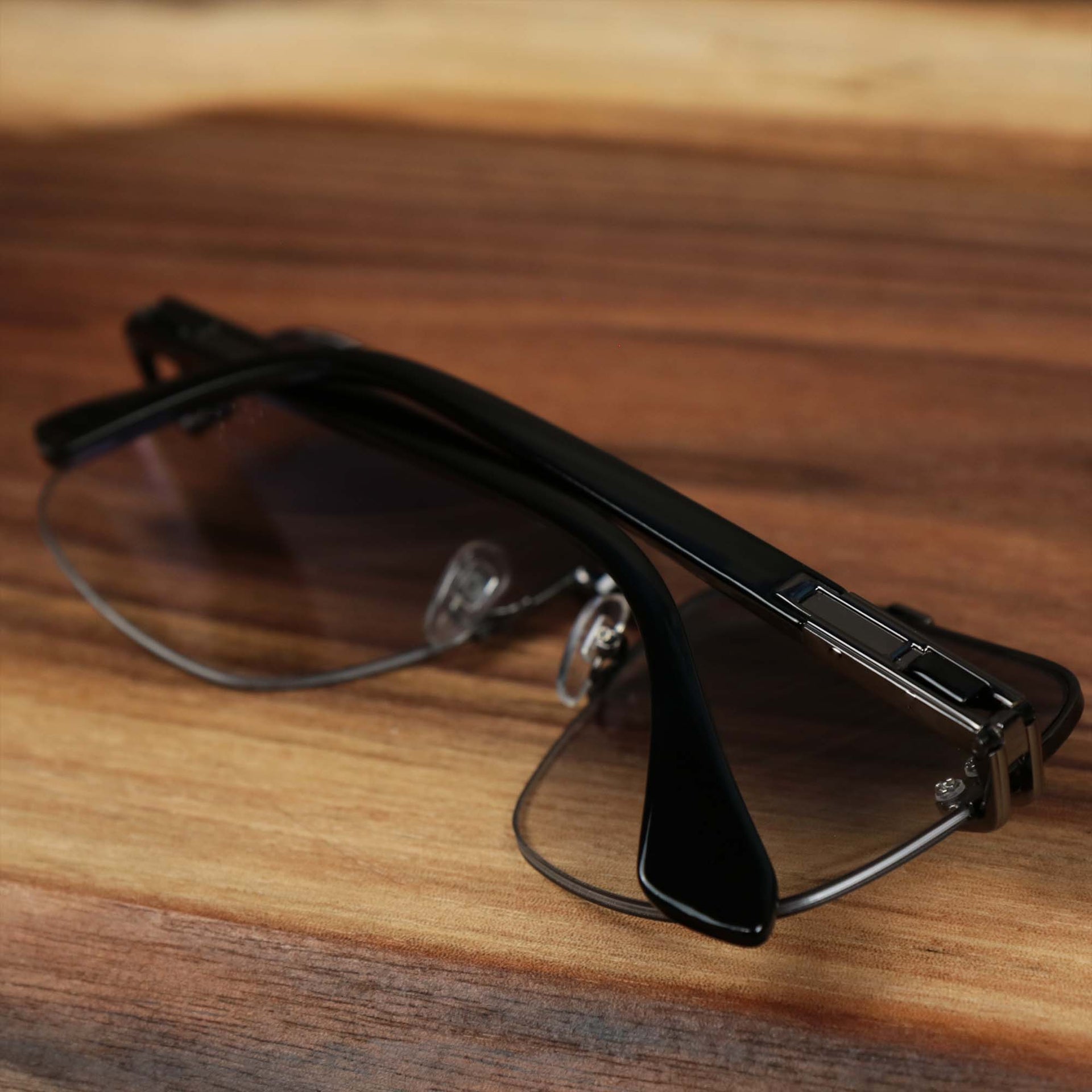The Round Rectangle Frame Black Lens Sunglasses with Black Frame folded up