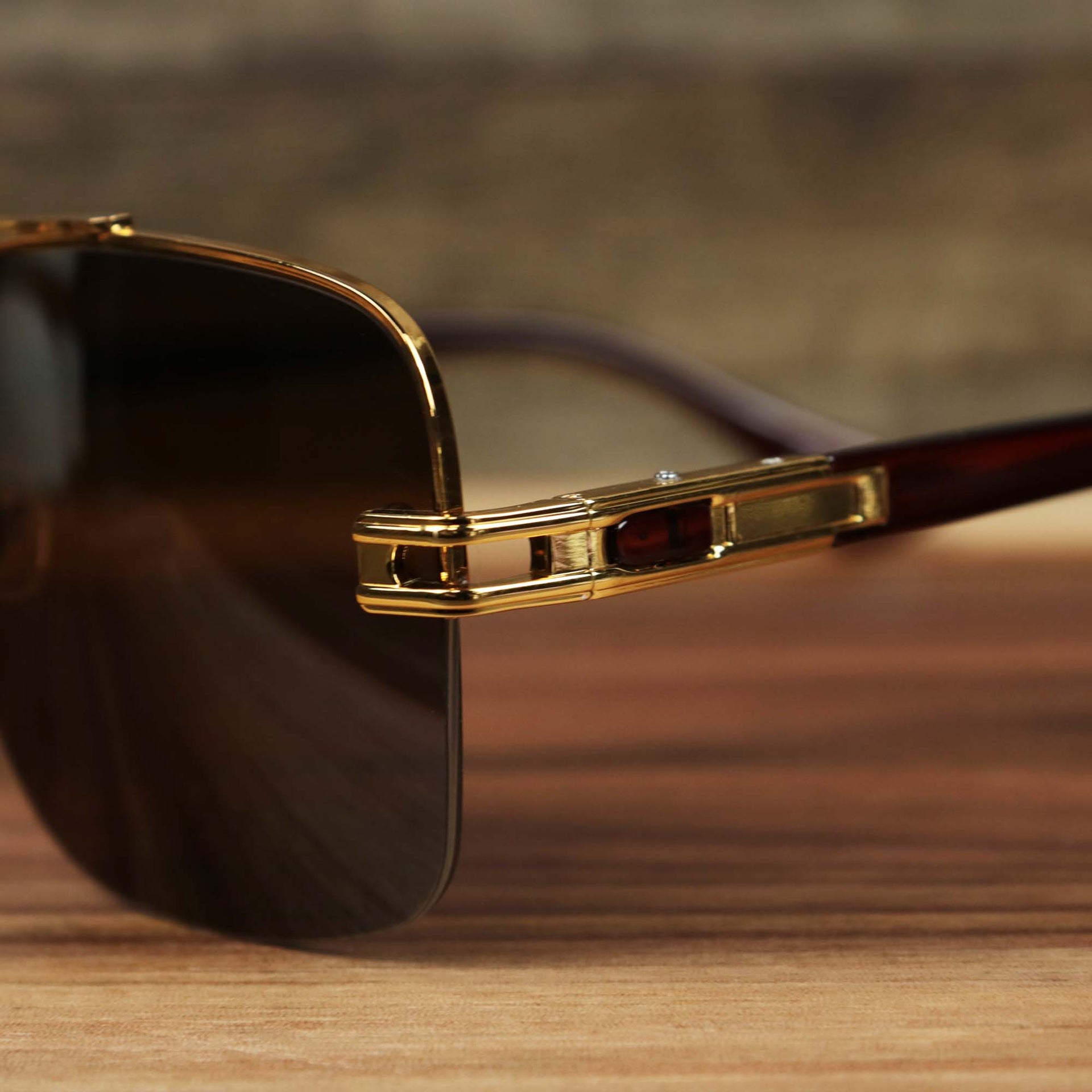 The hinge on the Round Rectangle Frame Black Lens Sunglasses with Gold Frame