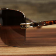 The hinge on the Round Rectangle Frame Brown Lens Sunglasses with Rose Gold Tortoise Frame