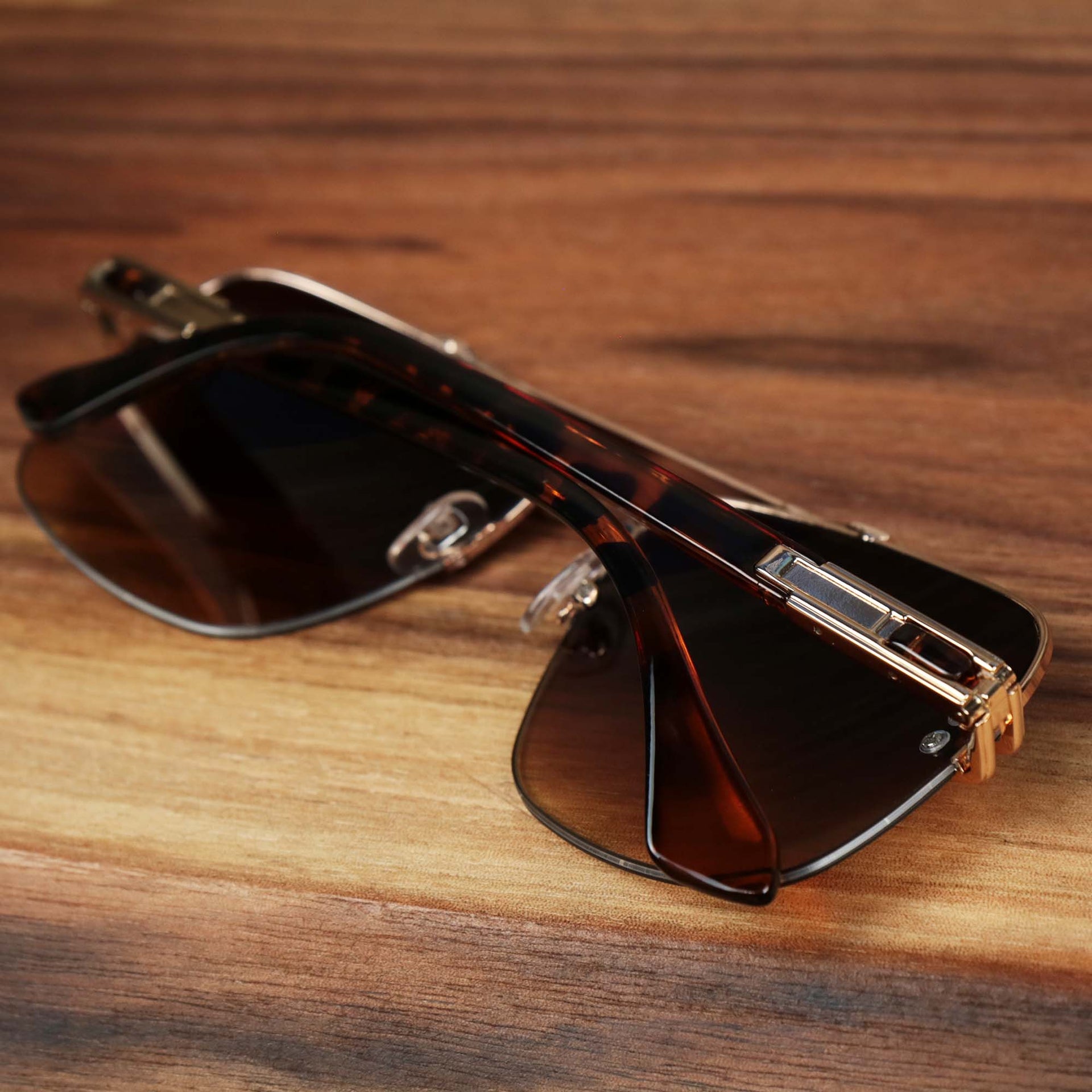 The Round Rectangle Frame Brown Lens Sunglasses with Rose Gold Tortoise Frame folded up