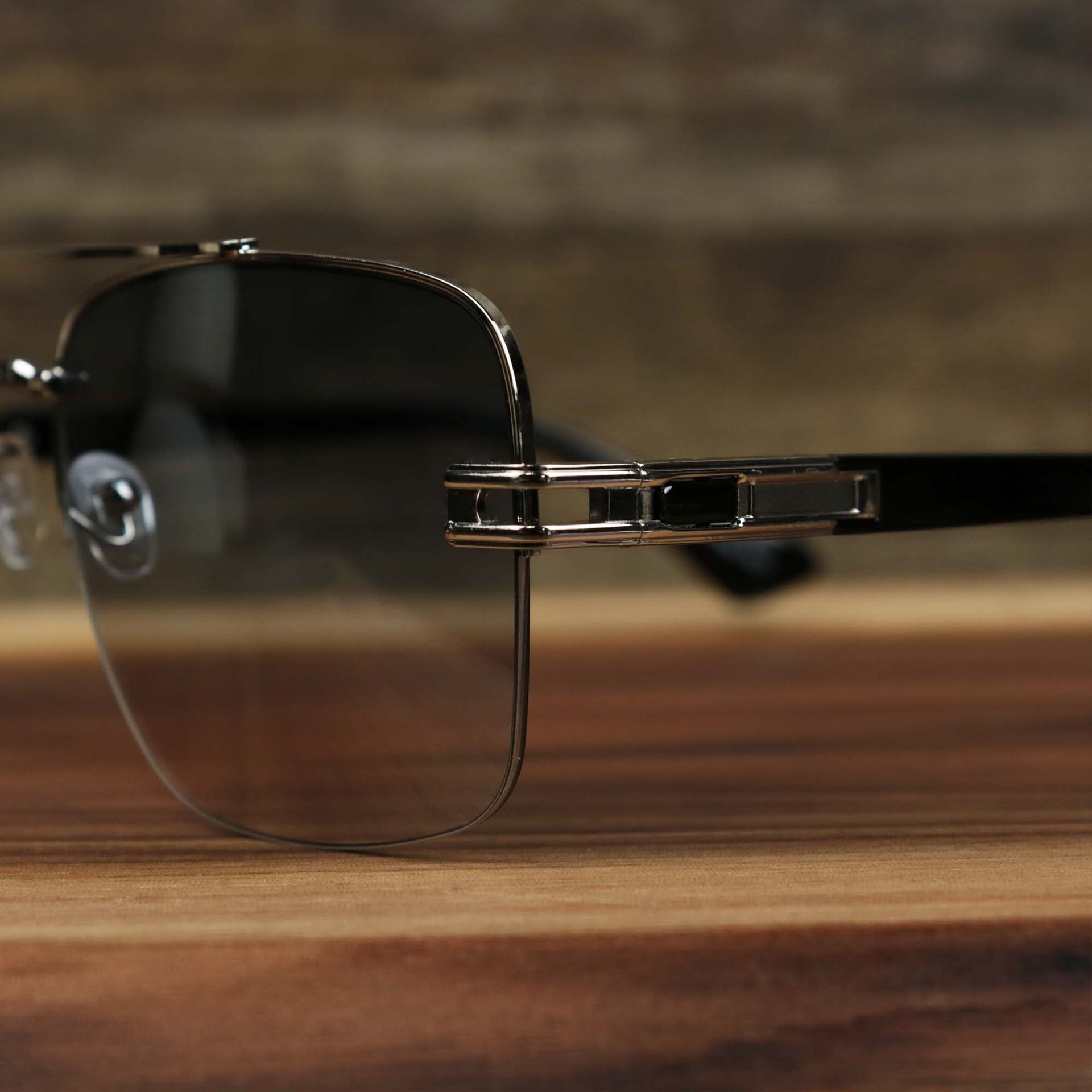 The hinge on the Round Rectangle Frame Blue Lens Sunglasses with Silver Frame