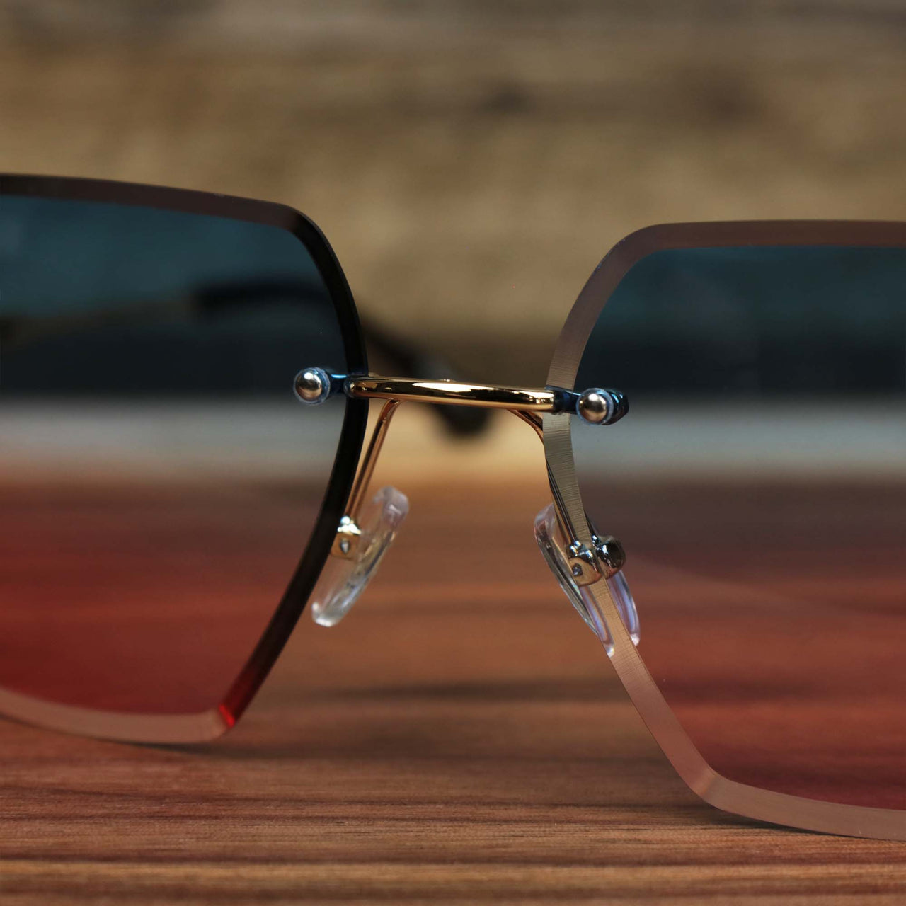 The bridge on the Large Lightweight Frame Pink Blue Gradient Lens Sunglasses with Gold Frame