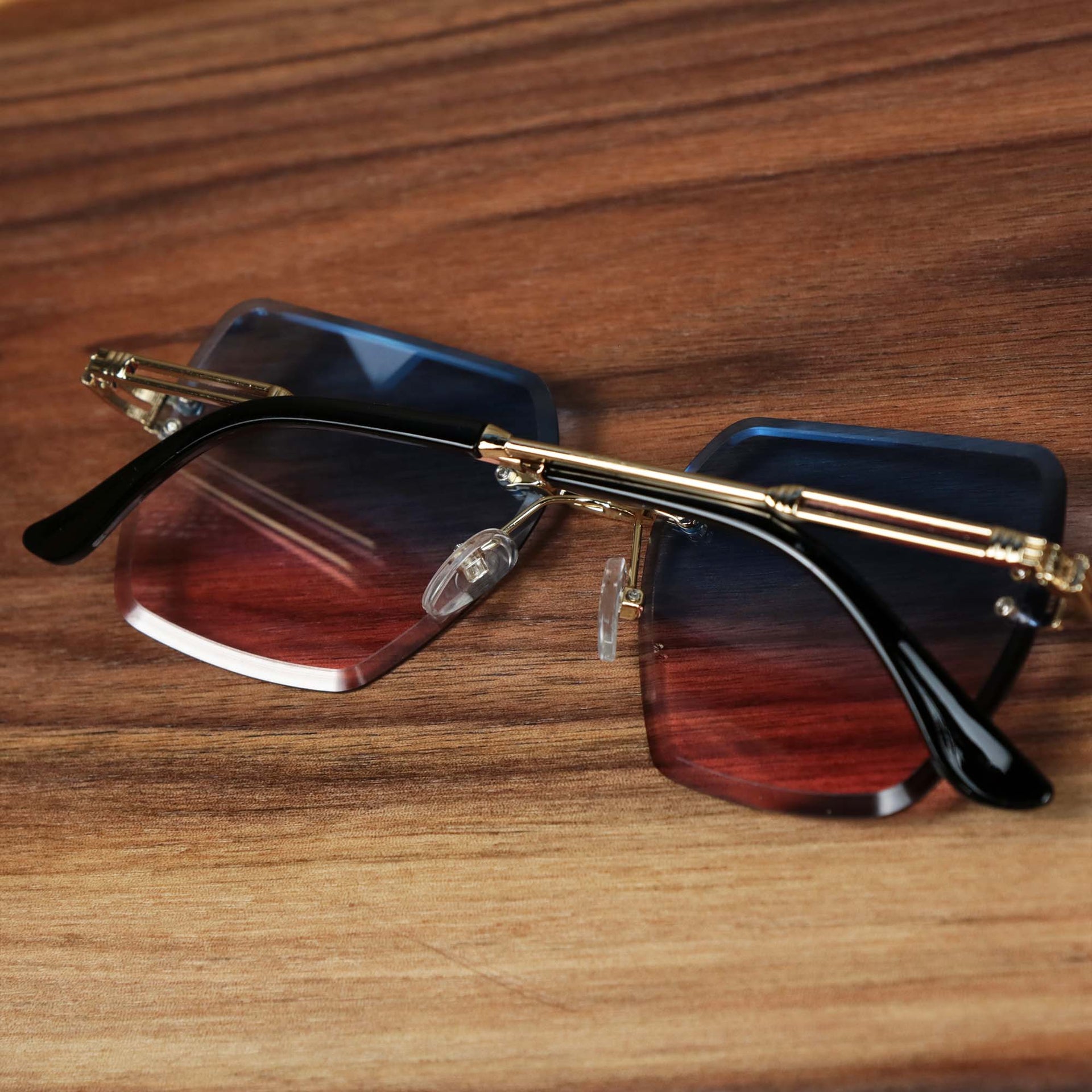The Large Lightweight Frame Pink Blue Gradient Lens Sunglasses with Gold Frame folded up