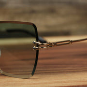 The hinge on the Large Lightweight Frame Green Lens Sunglasses with Gold Frame