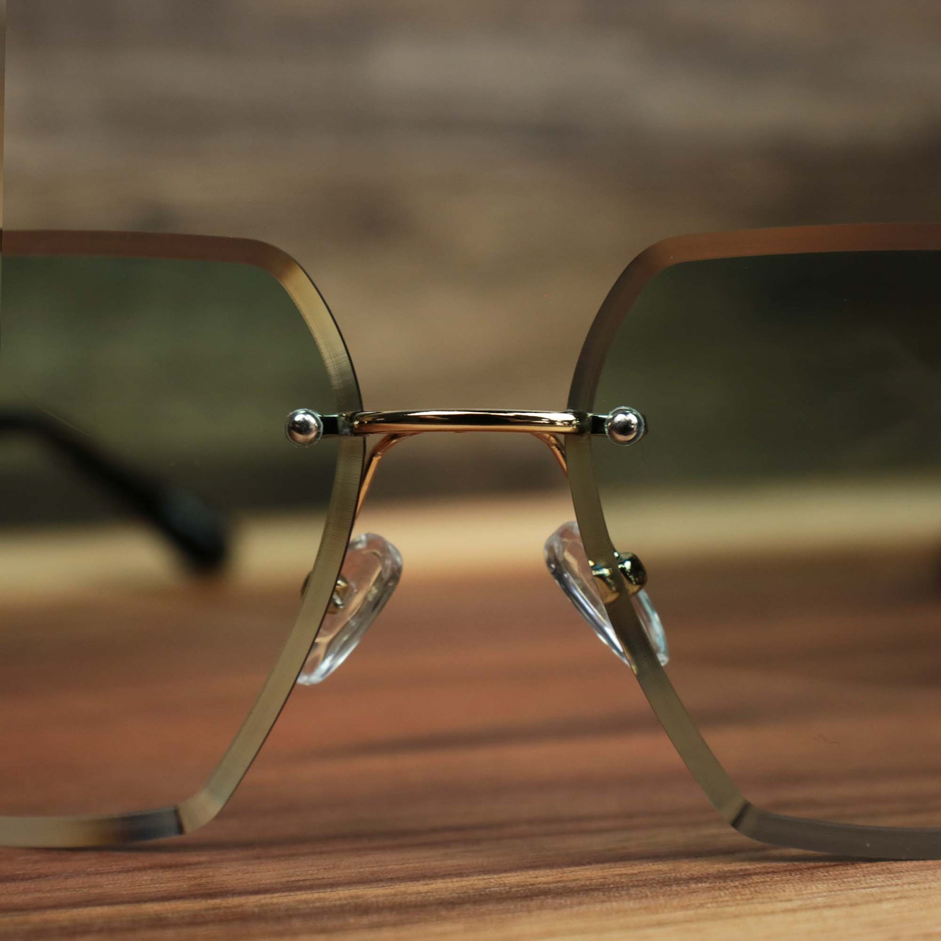 The bridge on the Large Lightweight Frame Green Lens Sunglasses with Gold Frame