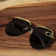 The Round Aviator Frames Black Lens Sunglasses with Gold Frame folded up
