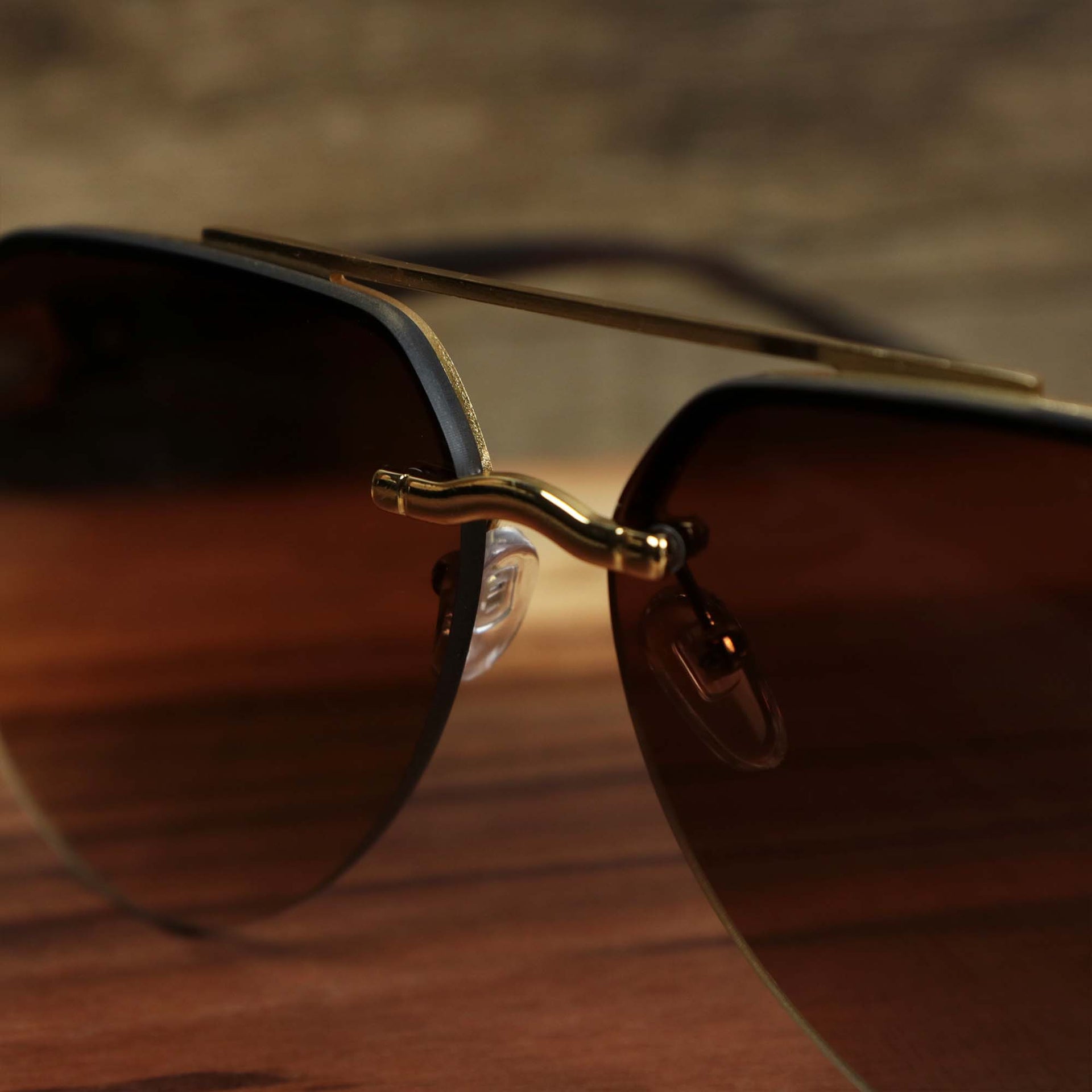 The bridge of the Round Aviator Frames Brown Gradient Lens Sunglasses with Gold Frame