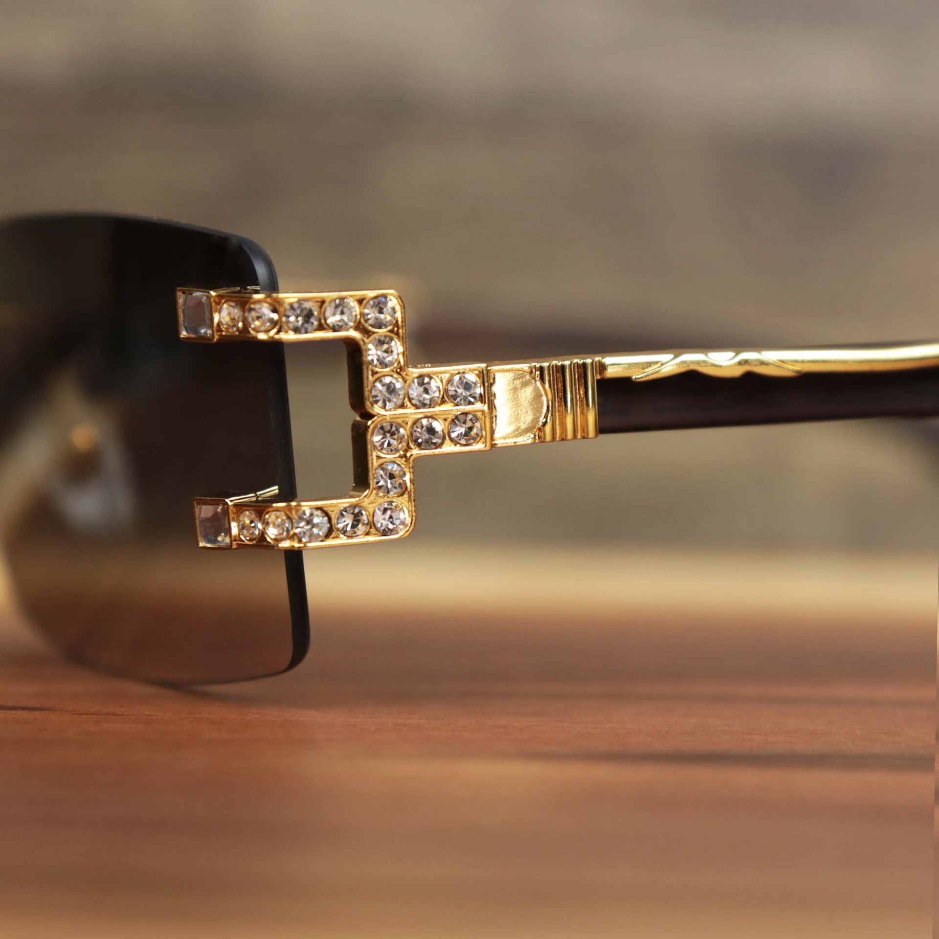 The hinge on the Rectangle Frames Black Lens Flooded Sunglasses with Gold Frame