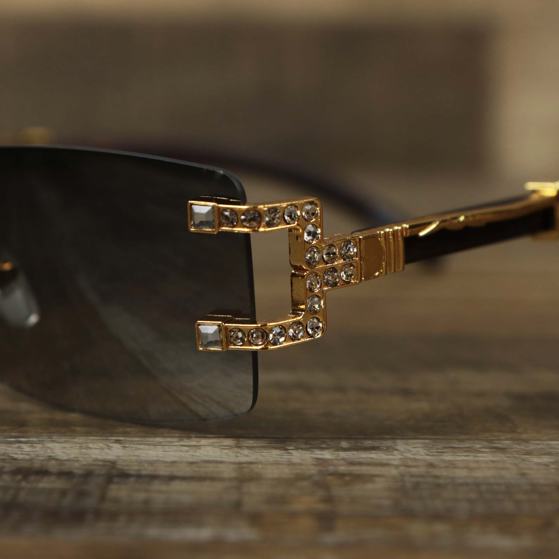 The hinge of the Rectangle Frames Black Gradient Lens Flooded Sunglasses with Gold Frame
