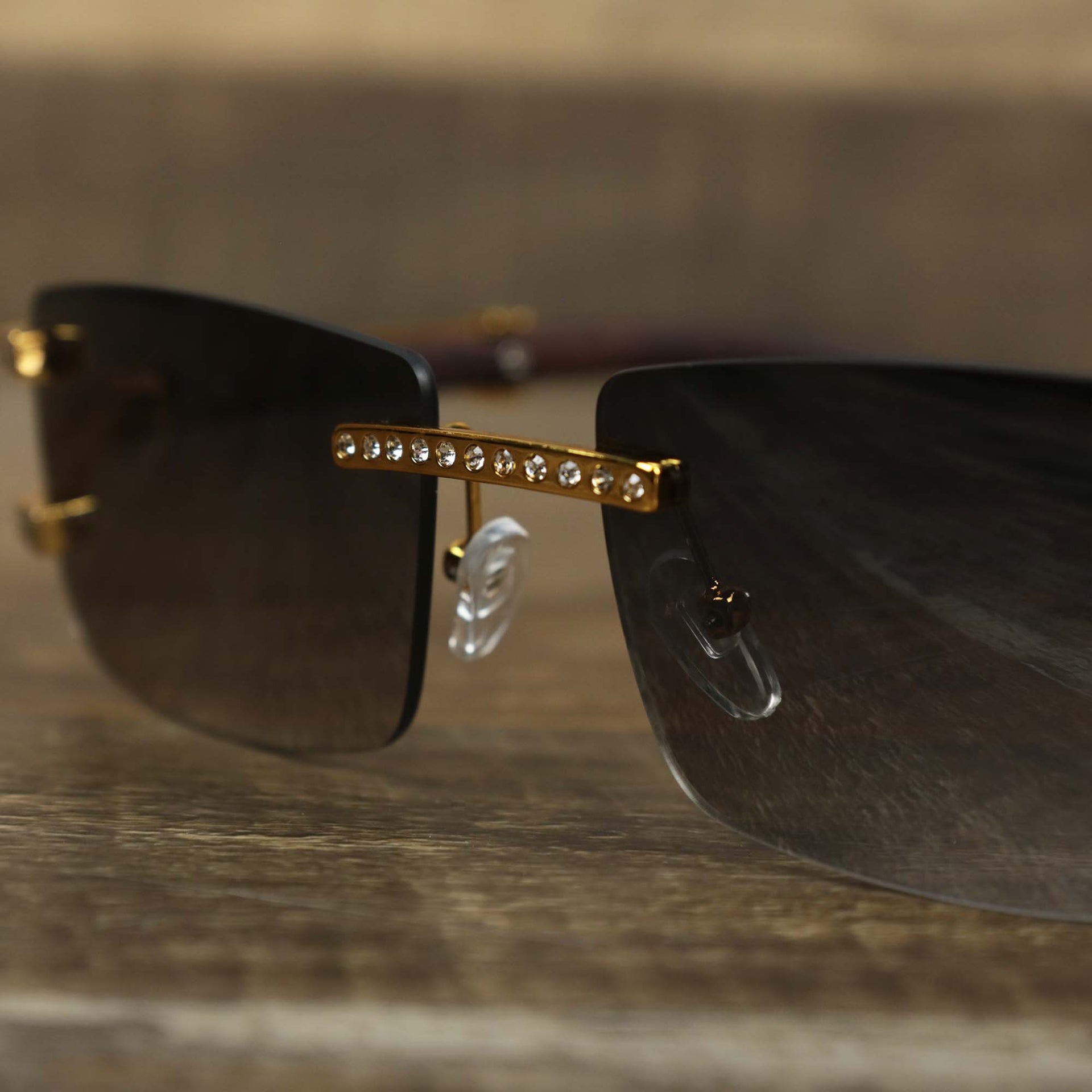 The bridge of the Rectangle Frames Black Gradient Lens Flooded Sunglasses with Gold Frame