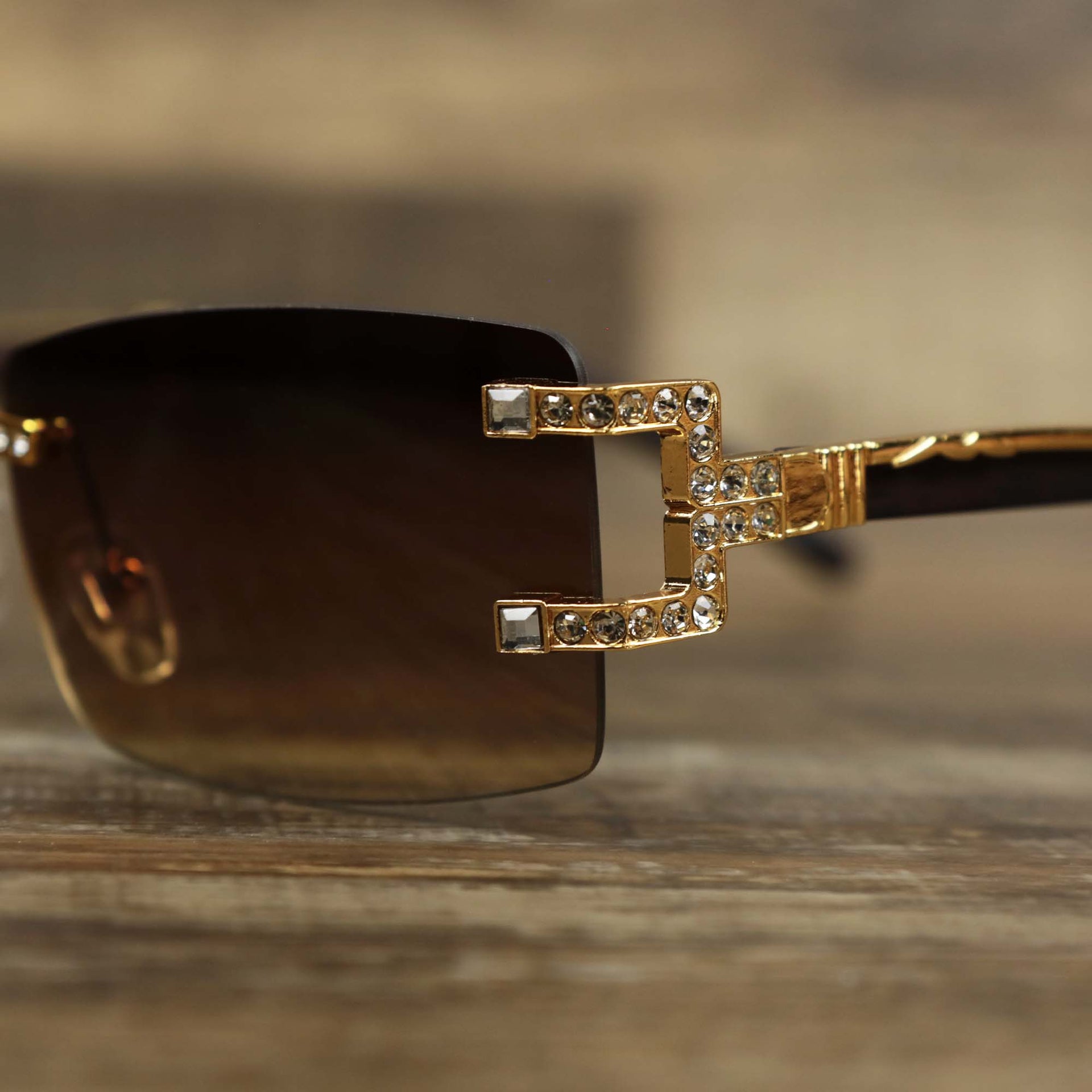 The hinge of the Rectangle Frames Brown Gradient Lens Flooded Sunglasses with Gold Frame