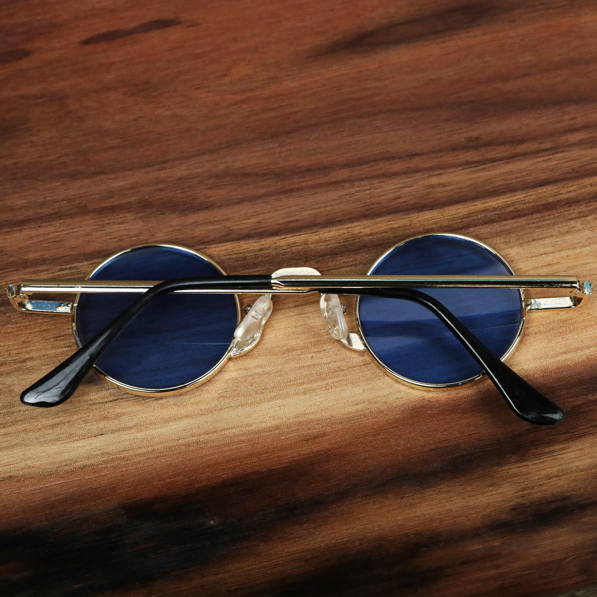 The Round Frames Blue Lens Sunglasses with Gold Frame folded up