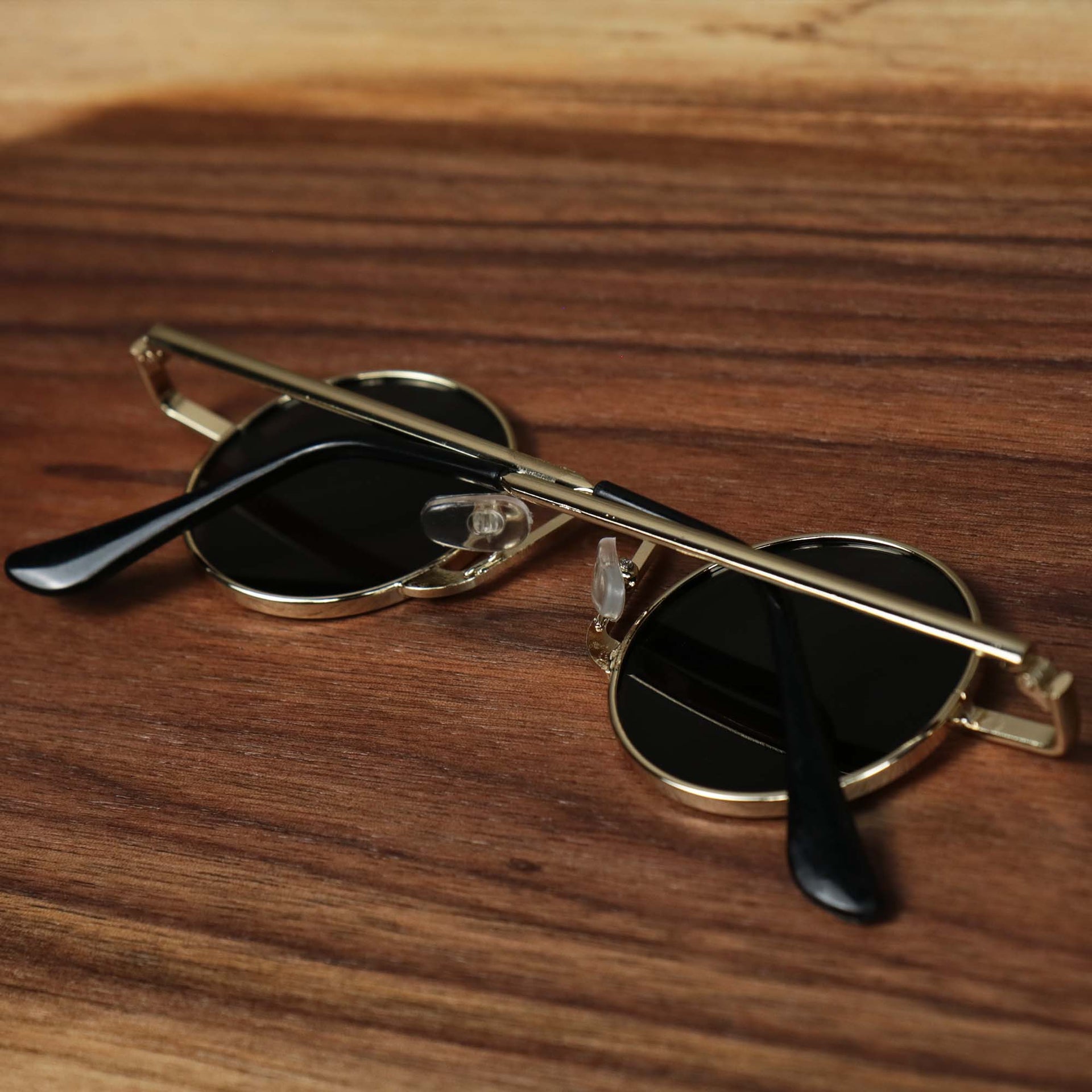 The Round Frames Black Lens Sunglasses with Gold Frame folded up